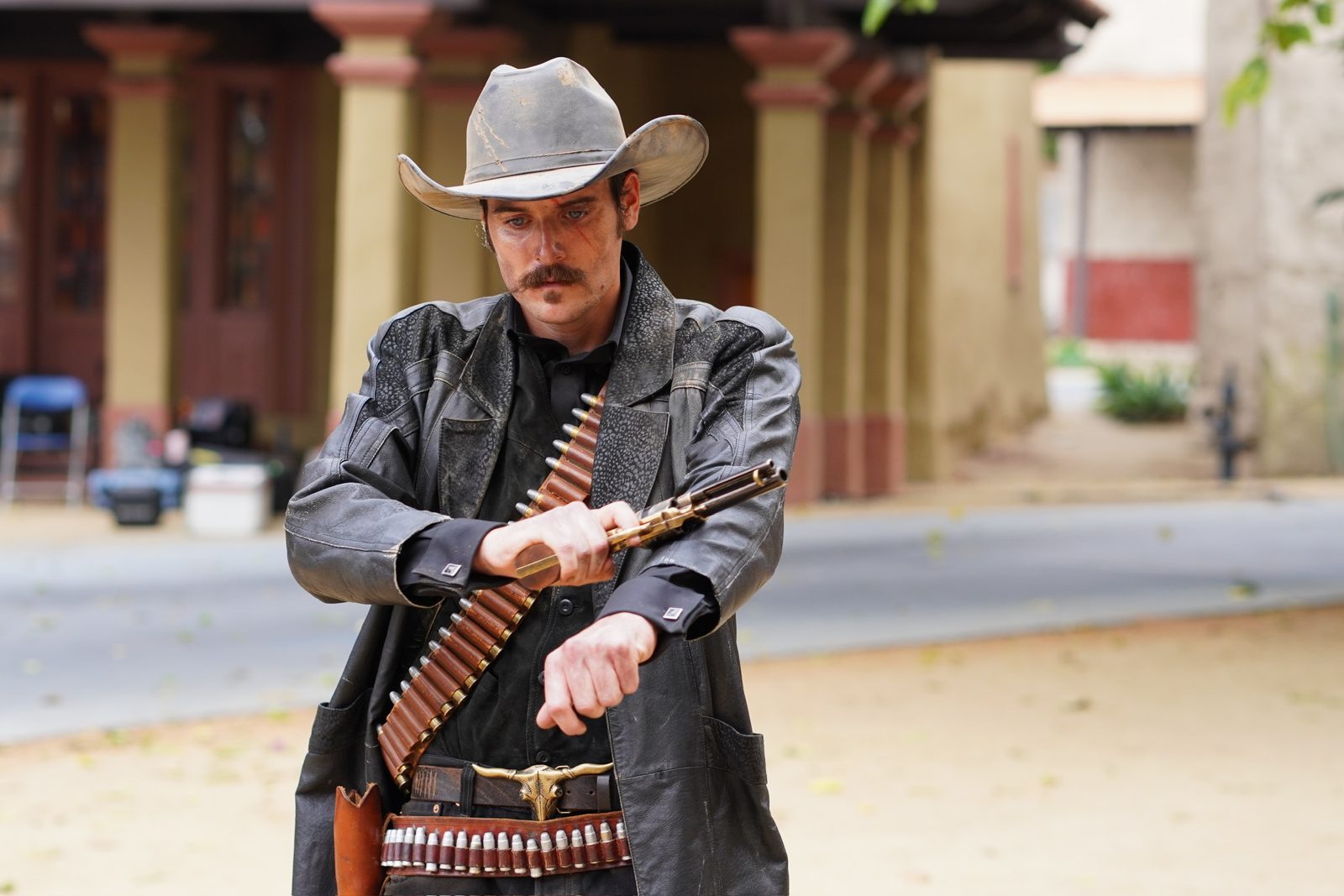 Stunt rehearsal, actor falling onto a crash mat outside the saloon set