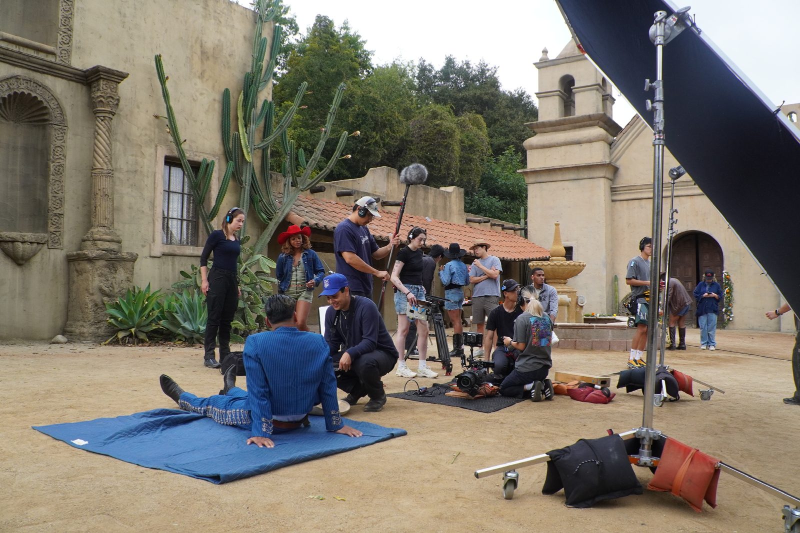 Cast and crew reviewing a setup on the Universal backlot