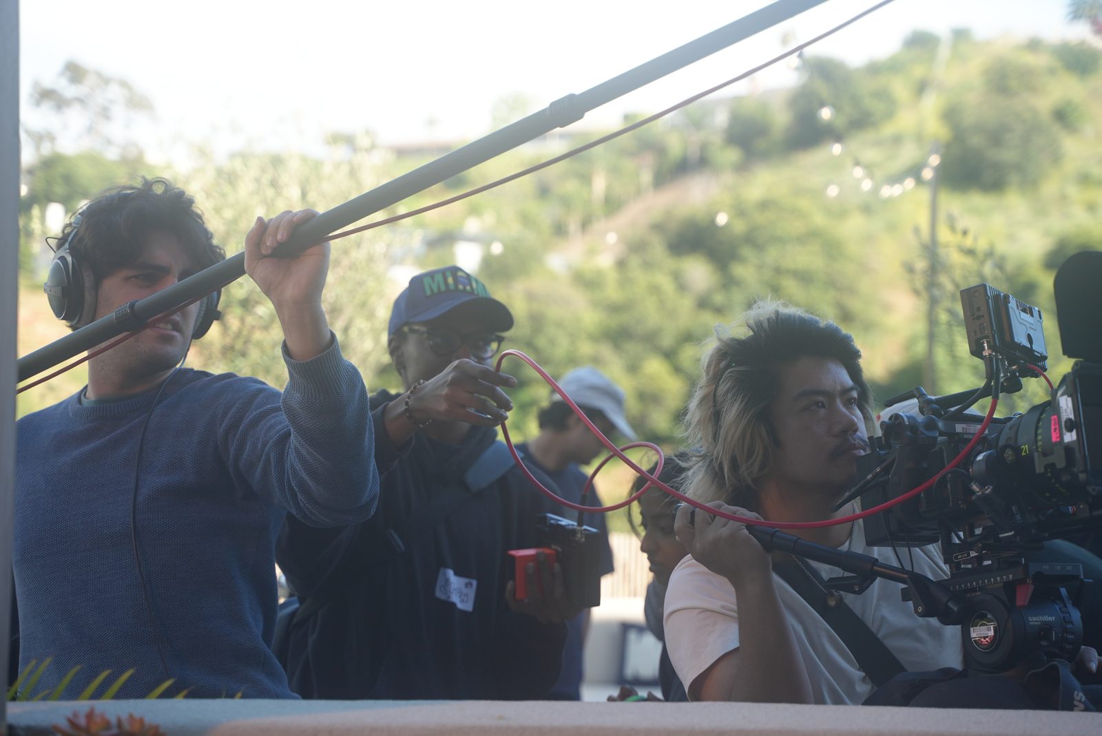 Boom operator and camera crew during a take